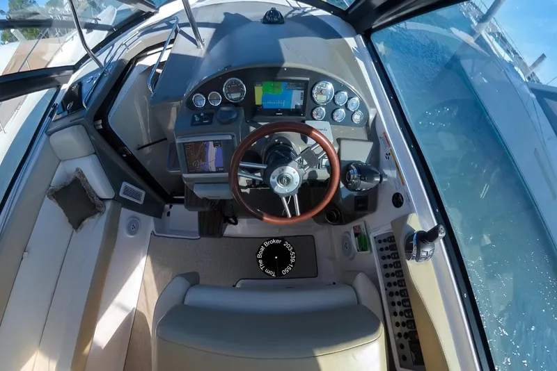 Slide: The Image of Cockpit of 2012 Regal 35 Sport Coupe with steering wheel and navigation controls. - 39