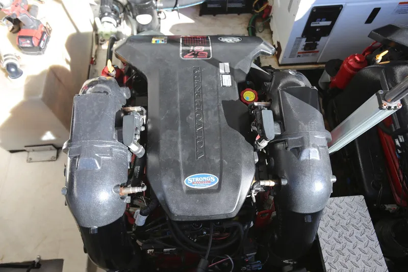 Slide: The Image of Engine compartment of a 2012 Regal 35 Sport Coupe boat, featuring a powerful motor. - 50