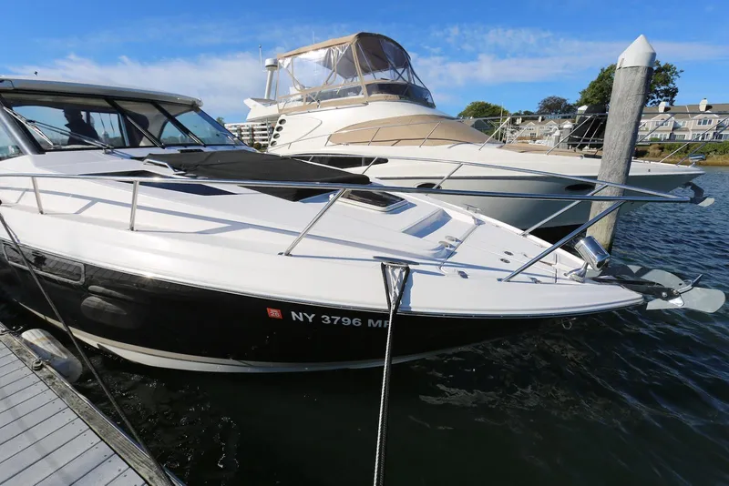 Slide: The Image of 2012 Regal 35 Sport Coupe docked at marina, sleek design, sunny day. - 58