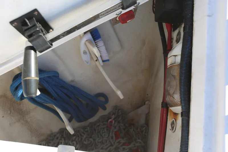 Slide: The Image of Storage compartment of a 2012 Regal 35 Sport Coupe with ropes, brush, and chains. - 68