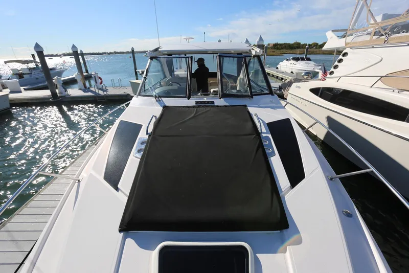 Slide: The Image of 2012 Regal 35 Sport Coupe docked at marina, sunny day, calm waters. - 70