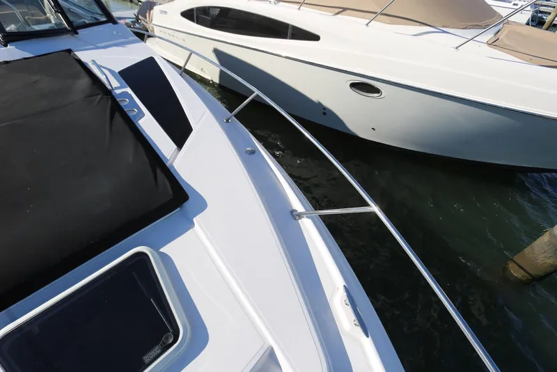 Slide: The Image of 2012 Regal 35 Sport Coupe docked beside another boat on the water. - 72