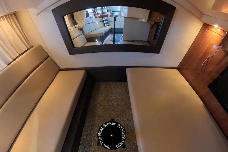 Slide: The Image of Interior of 2012 Regal 35 Sport Coupe with beige seating and wooden cabinetry. - 76