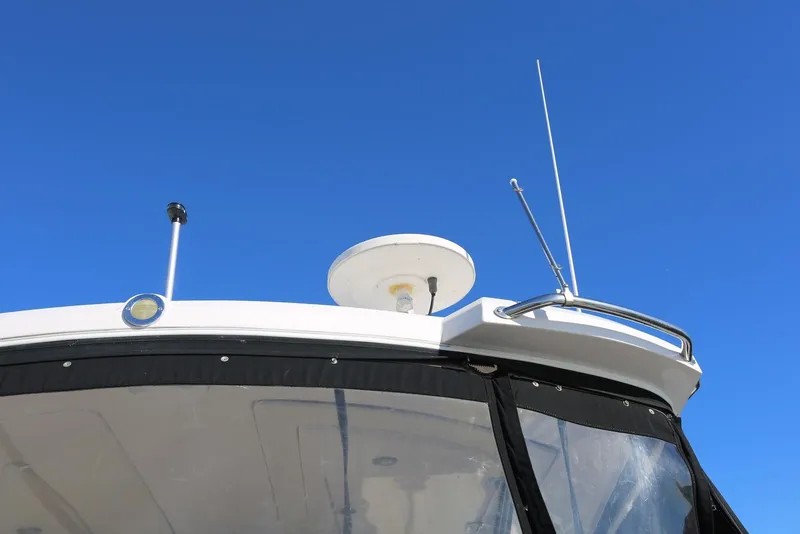 Slide: The Image of 2012 Regal 35 Sport Coupe boat roof with radar and antennas against clear blue sky. - 8