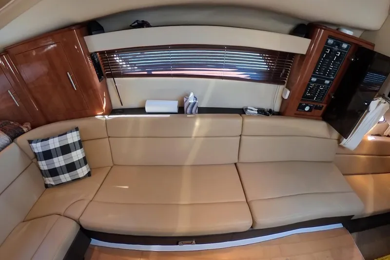 Slide: The Image of Interior of 2012 Regal 35 Sport Coupe with beige seating and wooden cabinetry. - 80