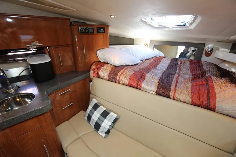 Slide: The Image of Interior of 2012 Regal 35 Sport Coupe with bed, kitchenette, and seating area. - 84
