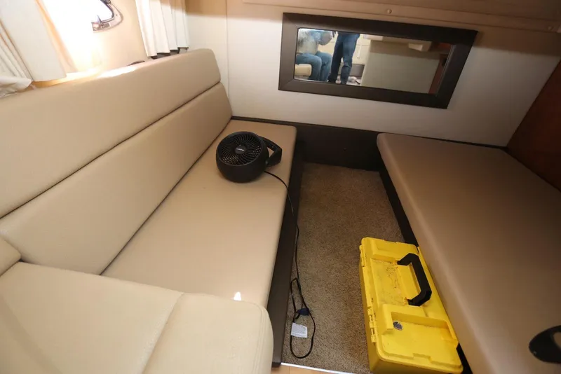 Slide: The Image of Interior of 2012 Regal 35 Sport Coupe with beige seating, fan, and yellow toolbox. - 89