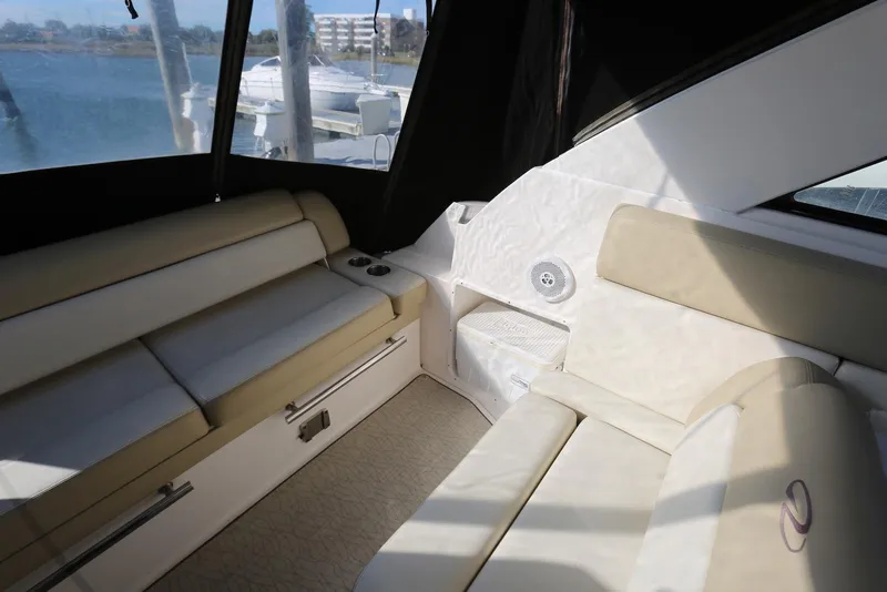 Slide: The Image of Interior of 2012 Regal 35 Sport Coupe with beige seating and waterfront view. - 9