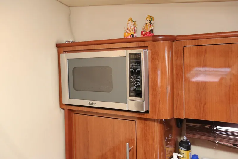 Slide: The Image of Haier microwave in 2012 Regal 35 Sport Coupe kitchen with wooden cabinetry. - 96