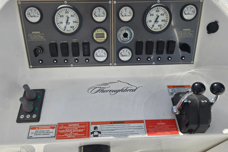 Slide: The Image of Control panel of a 2013 Thoroughbred 80'x 18' boat with gauges and switches. - 10