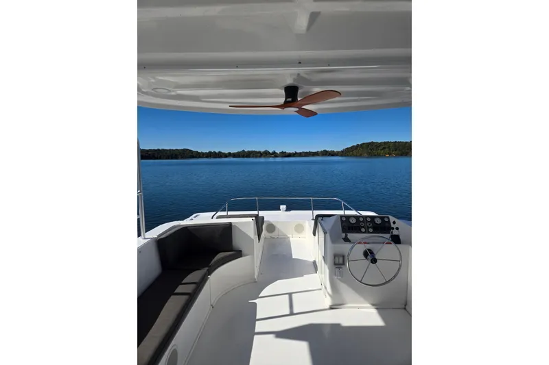 Slide: The Image of 2013 Thoroughbred 80'x 18' boat interior with lake view and modern helm. - 12