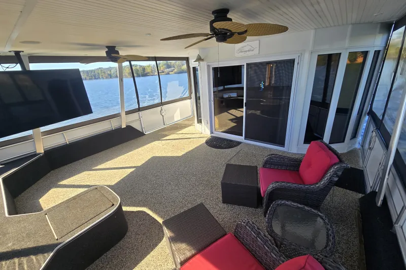 Slide: The Image of Luxurious 2013 Thoroughbred houseboat interior with lake view, featuring modern seating and large TV. - 14
