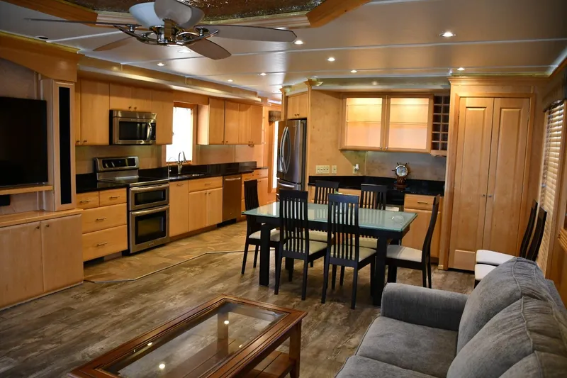 Slide: The Image of Luxurious 2013 Thoroughbred houseboat interior with modern kitchen, dining area, and cozy living space. - 24