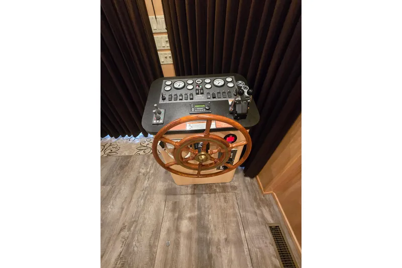 Slide: The Image of Control panel with wooden steering wheel on 2013 Thoroughbred 80'x 18' boat. - 27