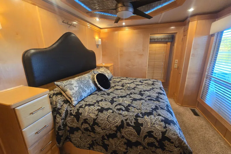 Slide: The Image of Luxurious bedroom in 2013 Thoroughbred 80'x 18' model with elegant decor and plush bedding. - 33