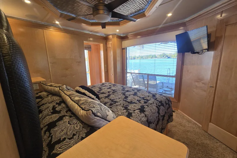 Slide: The Image of Luxurious 2013 Thoroughbred houseboat bedroom with lake view, elegant bedding, and modern amenities. - 35