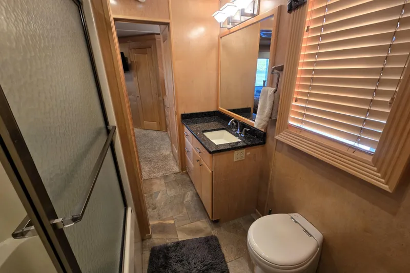 Slide: The Image of Modern bathroom in 2013 Thoroughbred model, featuring granite countertop and glass shower. - 37