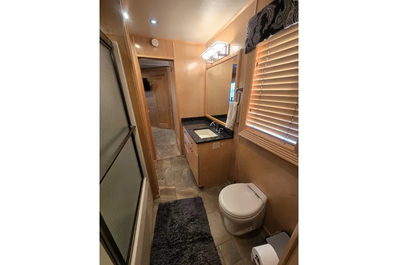 Slide: The Image of Luxurious bathroom in 2013 Thoroughbred 80'x 18' model with modern fixtures and elegant design. - 38