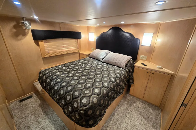 Slide: The Image of Luxurious bedroom in 2013 Thoroughbred 80'x 18' houseboat with elegant decor and cozy lighting. - 42