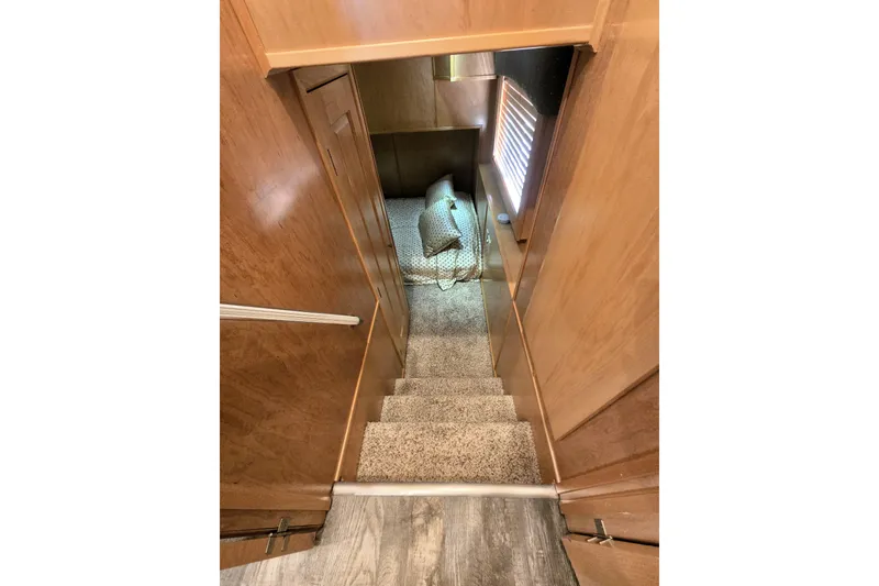 Slide: The Image of Interior view of 2013 Thoroughbred 80'x 18' with carpeted stairs and wooden walls. - 47