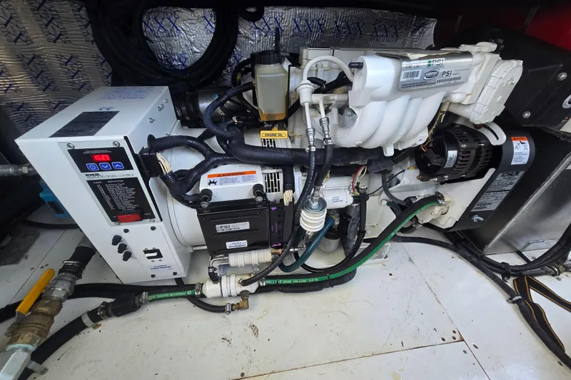 Slide: The Image of Engine compartment of a 2013 Thoroughbred 80'x 18' model, showcasing mechanical components. - 54