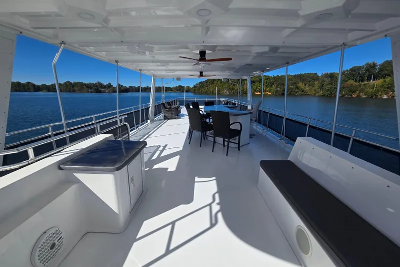 Slide: The Image of Spacious deck of 2013 Thoroughbred 80'x 18' houseboat on a serene lake. - 9
