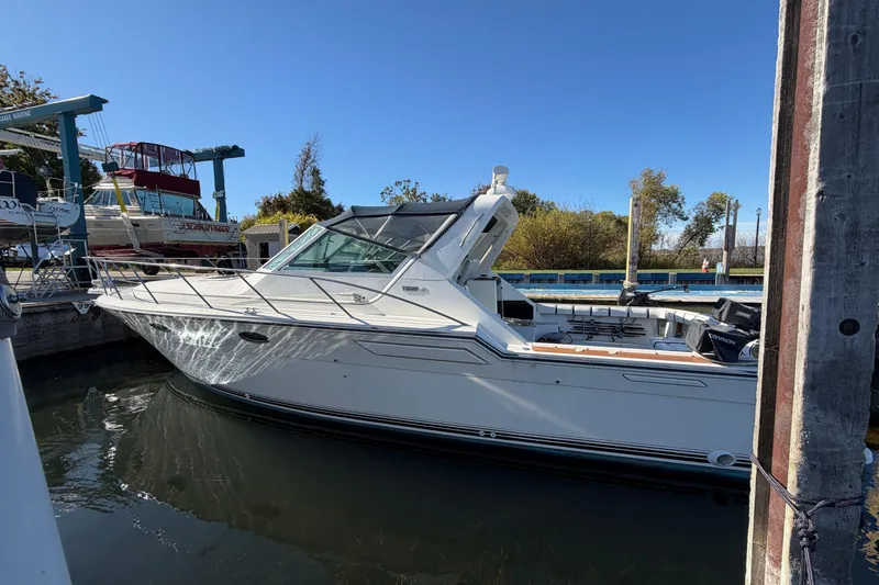 Slide: The Image of 1988 Tiara Yachts 3600 Open docked, showcasing sleek design and spacious deck. - 10