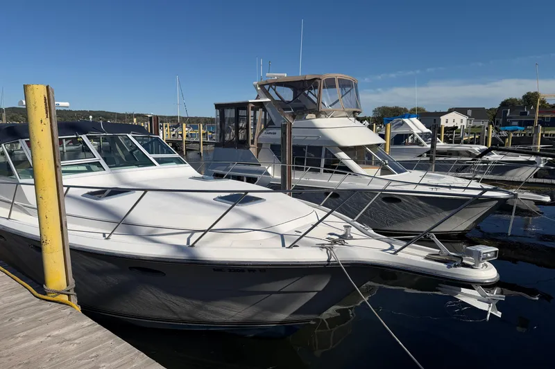 Slide: The Image of 1988 Tiara Yachts 3600 Open docked at a marina under clear blue skies. - 12