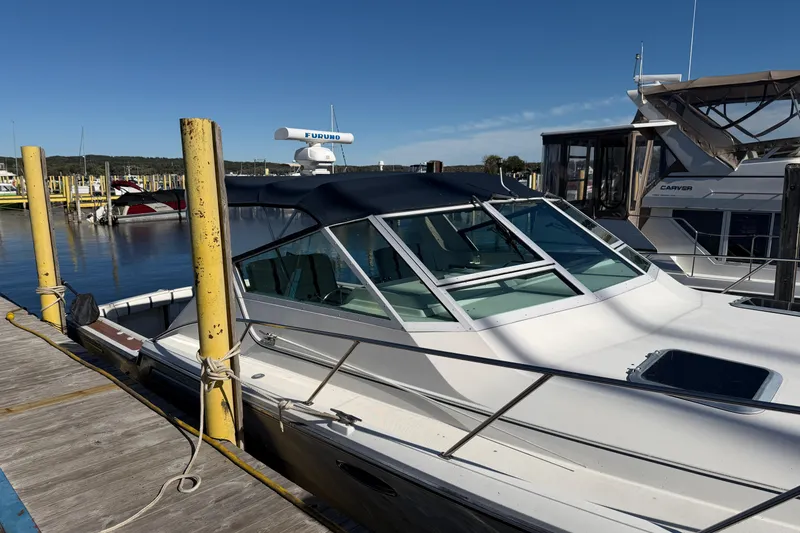 Slide: The Image of 1988 Tiara Yachts 3600 Open docked at marina under clear blue sky. - 14
