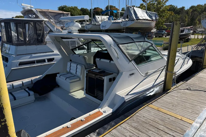 Slide: The Image of 1988 Tiara Yachts 3600 Open docked, showcasing sleek design and spacious cockpit. - 16