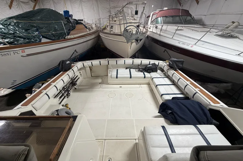 Slide: The Image of 1988 Tiara Yachts 3600 Open in storage, surrounded by other boats. - 21