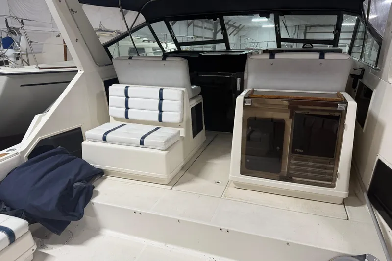 Slide: The Image of 1988 Tiara Yachts 3600 Open interior with seating and helm, showcasing classic design. - 22
