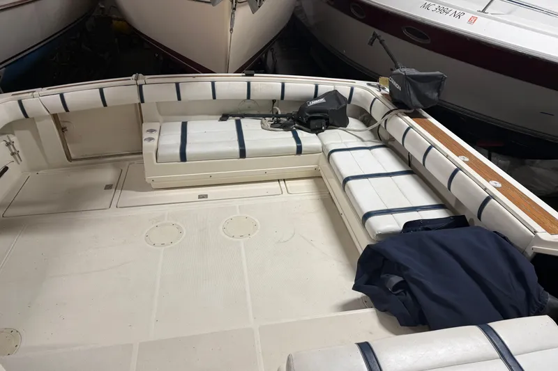 Slide: The Image of 1988 Tiara Yachts 3600 Open boat interior with white seating and fishing equipment. - 27