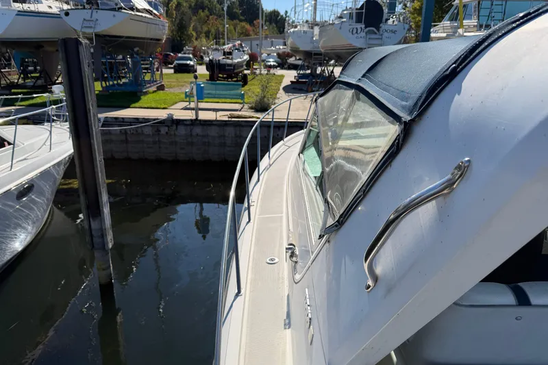 Slide: The Image of 1988 Tiara Yachts 3600 Open docked, showcasing sleek design and marina surroundings. - 28