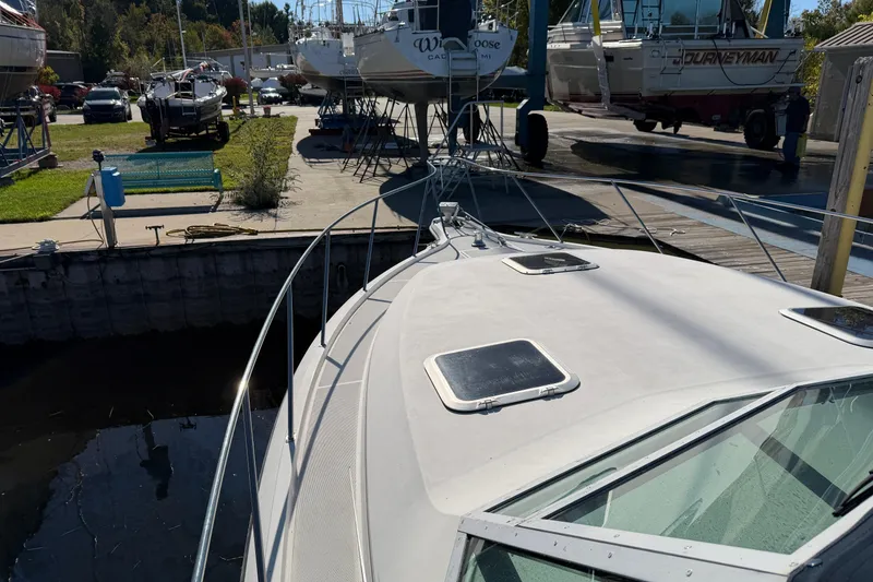 Slide: The Image of 1988 Tiara Yachts 3600 Open docked at a marina with other boats. - 29