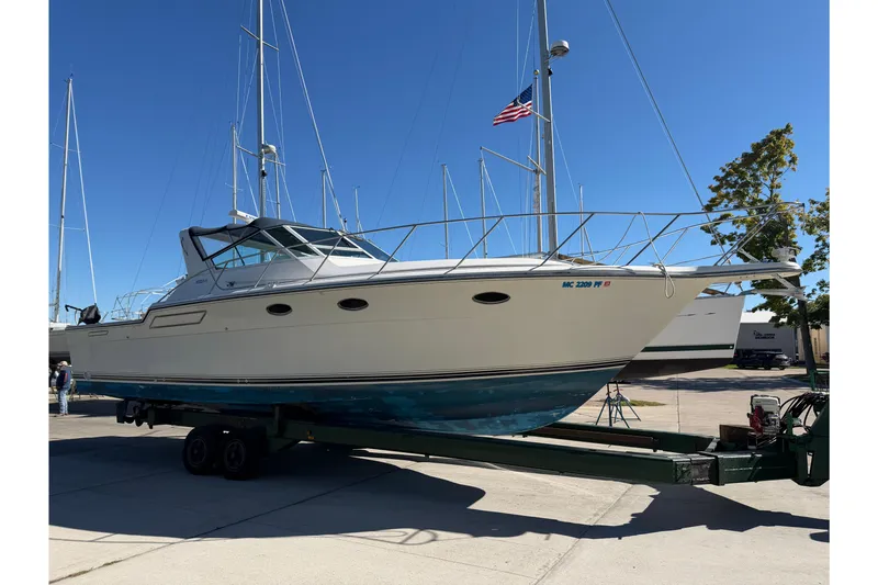 Slide: The Image of 1988 Tiara Yachts 3600 Open on trailer, docked under clear blue sky. - 3
