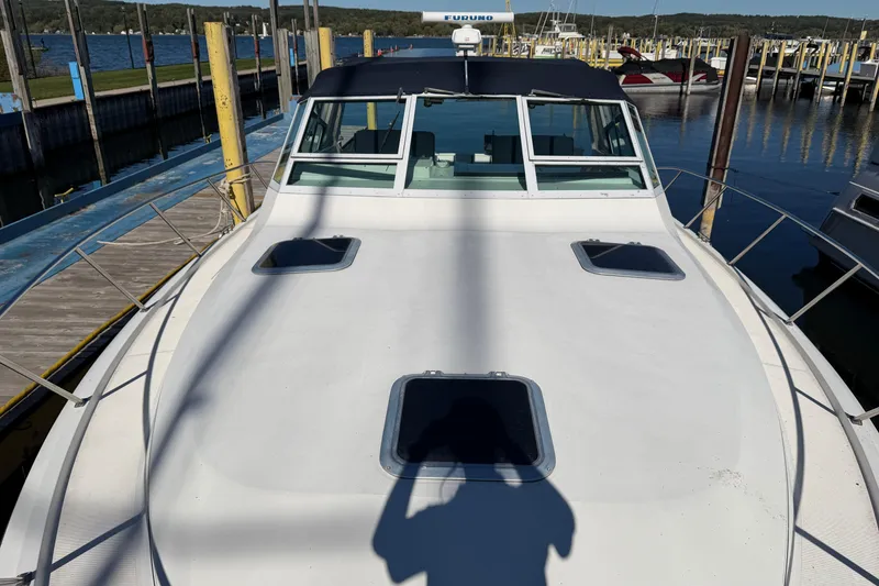 Slide: The Image of 1988 Tiara Yachts 3600 Open docked at marina, front deck view. - 33