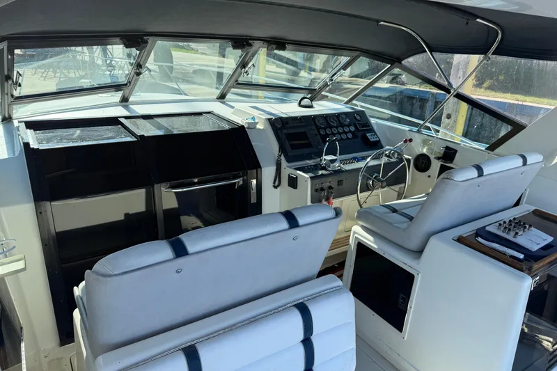 Slide: The Image of 1988 Tiara Yachts 3600 Open cockpit with steering wheel and control panel. - 35
