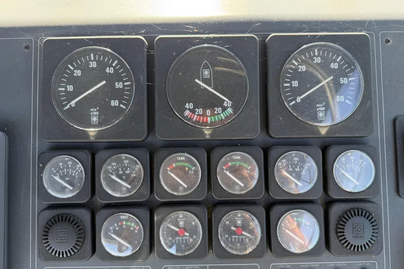 Slide: The Image of Dashboard of a 1988 Tiara Yachts 3600 Open with various gauges and indicators. - 37