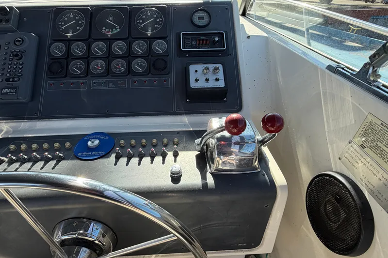 Slide: The Image of Control panel of a 1988 Tiara Yachts 3600 Open with gauges and throttle levers. - 41