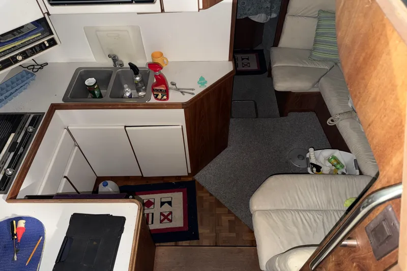 Slide: The Image of Interior of 1988 Tiara Yachts 3600 Open, featuring kitchen and seating area. - 46