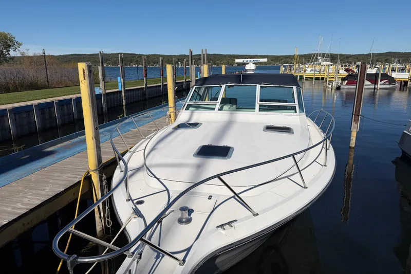 Slide: The Image of 1988 Tiara Yachts 3600 Open docked at a marina on a sunny day. - 5