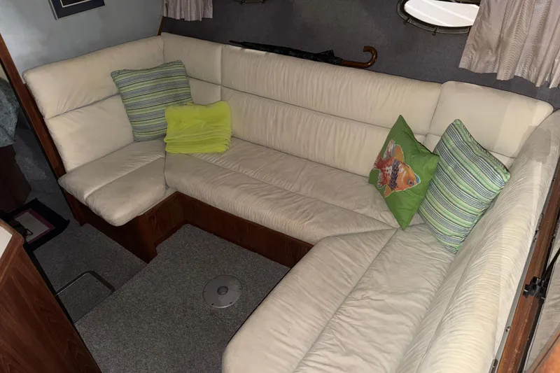 Slide: The Image of Interior of 1988 Tiara Yachts 3600 Open with cream leather seating and decorative pillows. - 50