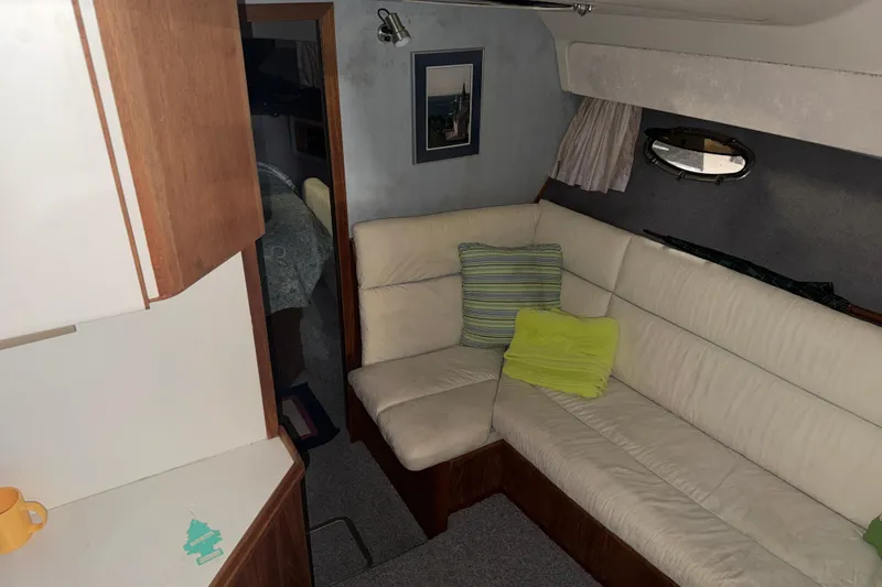 Slide: The Image of 1988 Tiara Yachts 3600 Open interior with cream leather seating and wooden cabinetry. - 51