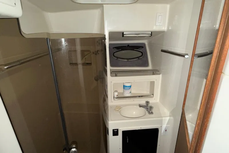 Slide: The Image of 1988 Tiara Yachts 3600 Open bathroom with sink, mirror, and shower. - 55