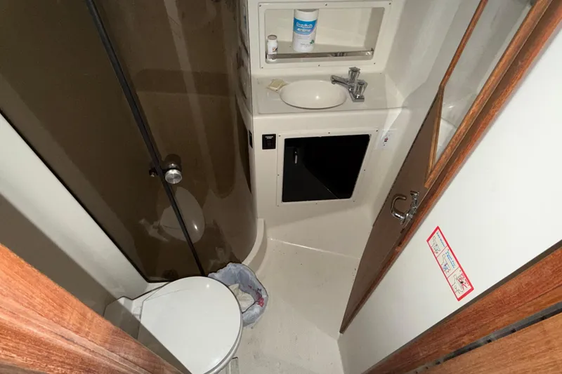 Slide: The Image of 1988 Tiara Yachts 3600 Open bathroom with sink, toilet, and storage. - 56