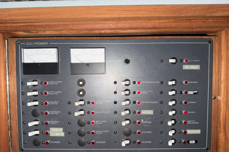 Slide: The Image of 1988 Tiara Yachts 3600 Open DC power control panel with switches and gauges. - 64