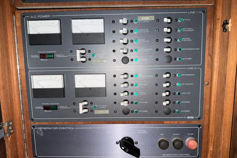 Slide: The Image of Electrical control panel of a 1988 Tiara Yachts 3600 Open, featuring various switches and meters. - 65