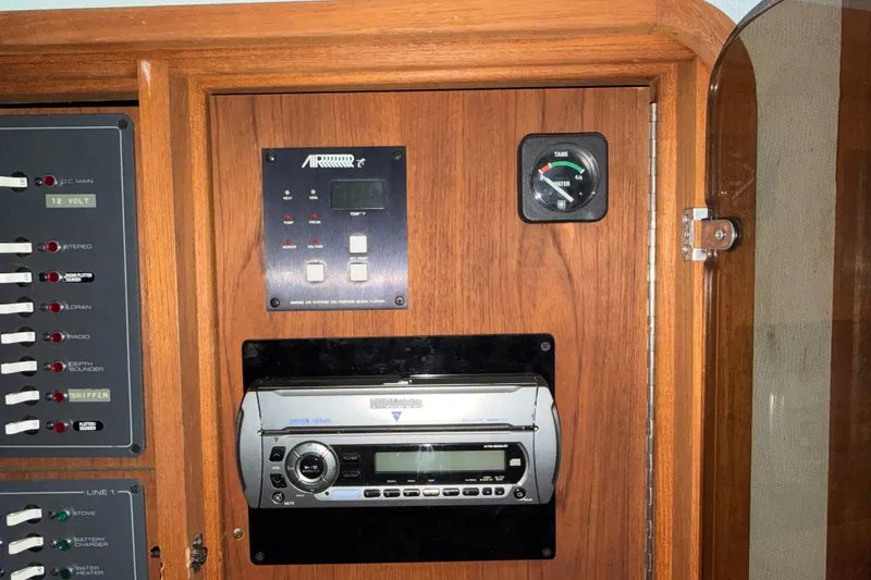Slide: The Image of Control panel of a 1988 Tiara Yachts 3600 Open, featuring gauges and a stereo system. - 66