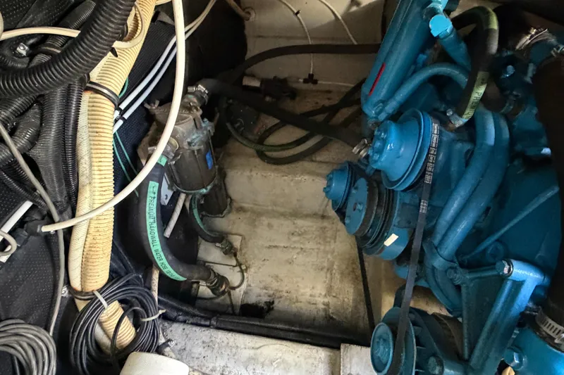 Slide: The Image of Engine compartment of a 1988 Tiara Yachts 3600 Open, showcasing mechanical components and wiring. - 71